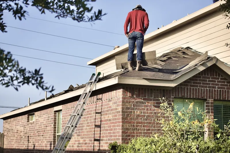 Professional roofer working on a residential roof in Sheboygan Falls